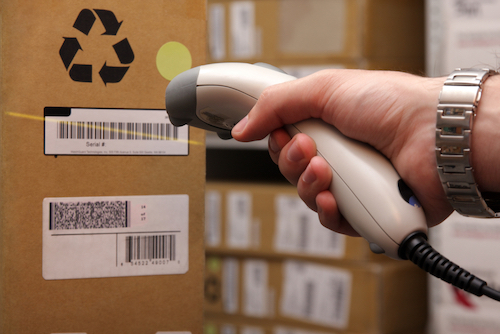 Man hand with barcode scanner in operation